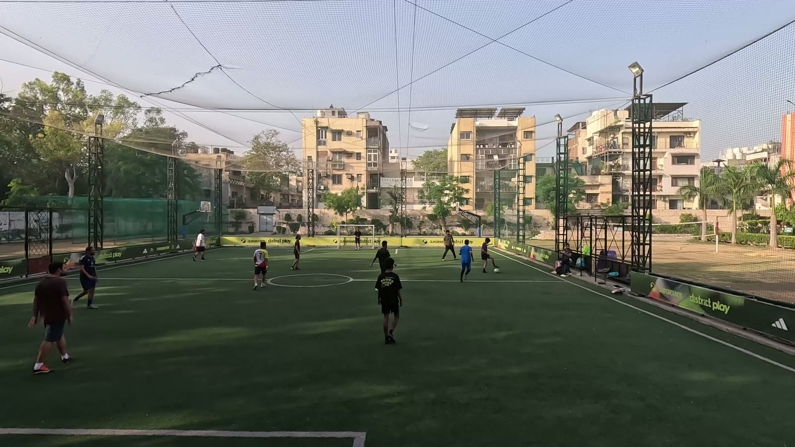 Wide view of a caged turf football pitch
